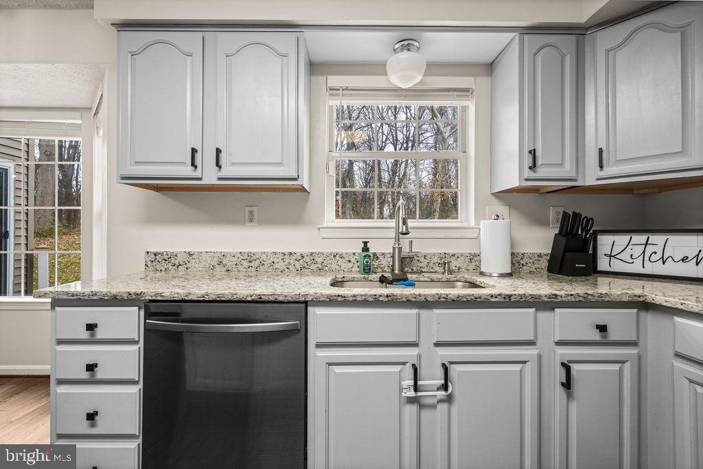 9803 Bald Hill Road Bowie, MD 20721 - Photo 21 of 55 a kitchen with granite countertop stainless steel appliances a sink and cabinets