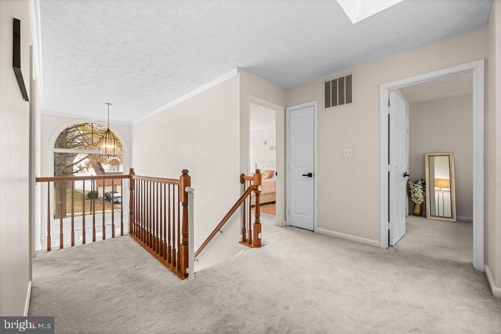 9803 Bald Hill Road Bowie, MD 20721 - Photo 23 of 55 a view of a hallway with a chandelier and entryway