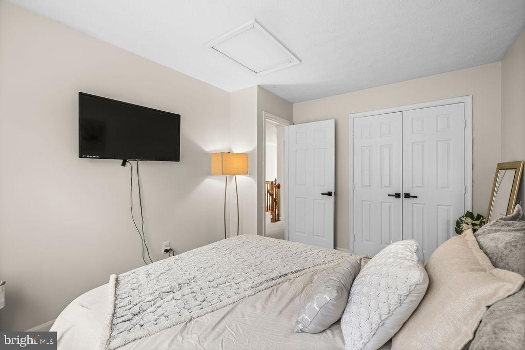 9803 Bald Hill Road Bowie, MD 20721 - Photo 25 of 55 a bedroom with a bed and a flat screen tv