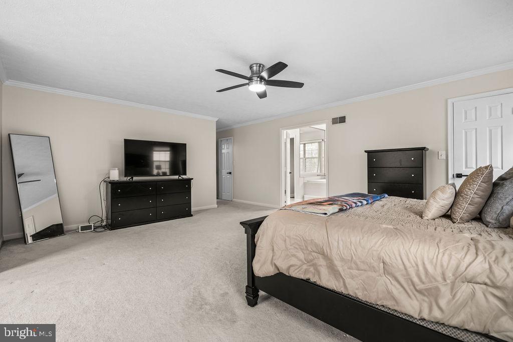 9803 Bald Hill Road Bowie, MD 20721 - Photo 30 of 55 a bedroom with a bed and a flat screen tv