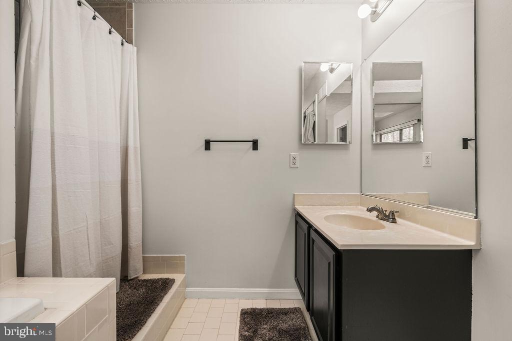 9803 Bald Hill Road Bowie, MD 20721 - Photo 32 of 55 a bathroom with a sink and a mirror