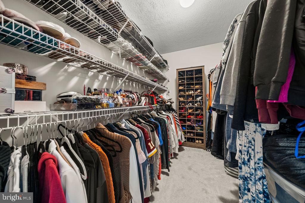 9803 Bald Hill Road Bowie, MD 20721 - Photo 35 of 55 a view of walk in closet with clothes and shoes