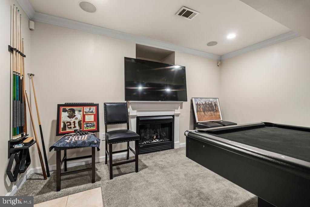 9803 Bald Hill Road Bowie, MD 20721 - Photo 40 of 55 a living room with furniture a flat screen tv and a fireplace