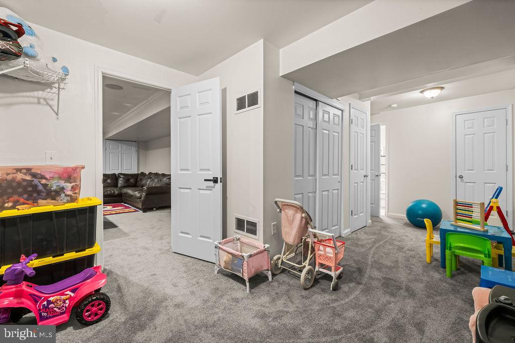 9803 Bald Hill Road Bowie, MD 20721 - Photo 41 of 55 a living room with furniture and a baby crib