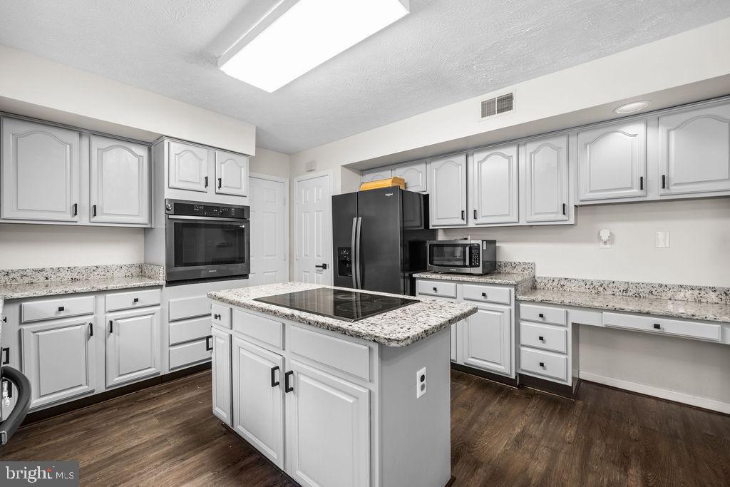 9803 Bald Hill Road Bowie, MD 20721 - Photo 43 of 55 a kitchen with white cabinets sink and stainless steel appliances