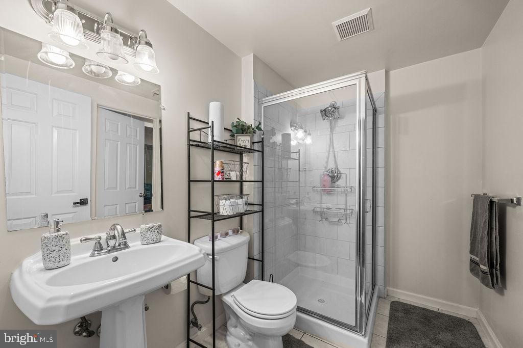 9803 Bald Hill Road Bowie, MD 20721 - Photo 44 of 55 a bathroom with a sink toilet and shower