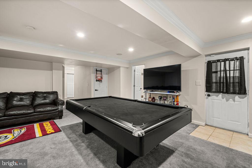 9803 Bald Hill Road Bowie, MD 20721 - Photo 45 of 55 a living room with furniture and a flat screen tv