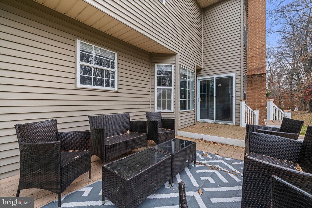 9803 Bald Hill Road Bowie, MD 20721 - Photo 50 of 55 a view of a deck with couches chairs with wooden floor
