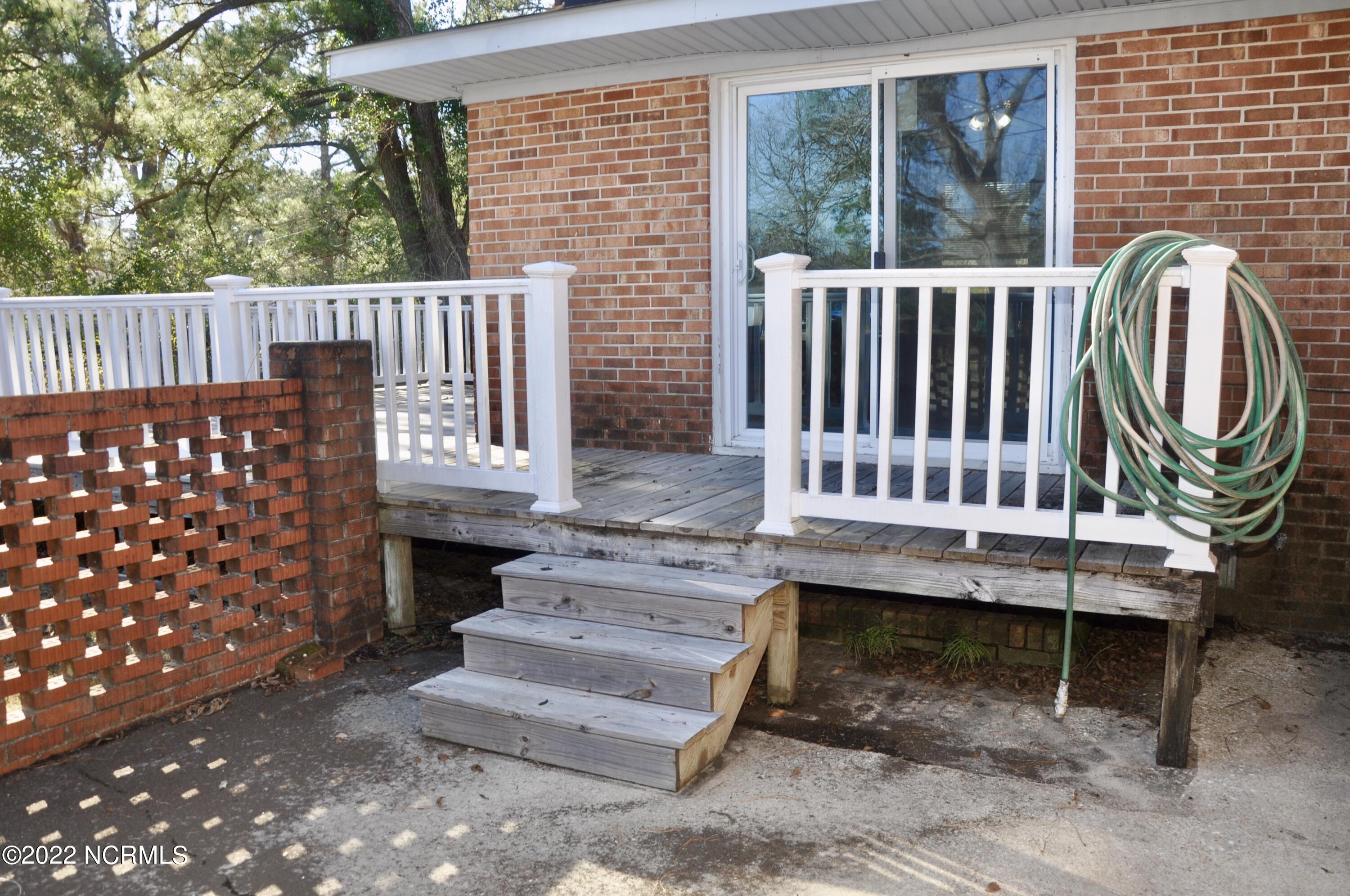 2308 Rockhill Road Castle Hayne, NC 28429 - Photo 25 of 31 Patio to deck (sliders enter the den)
