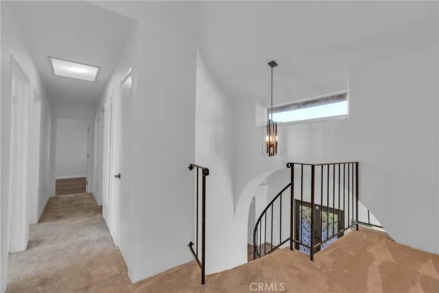 a view of hallway with chandelier