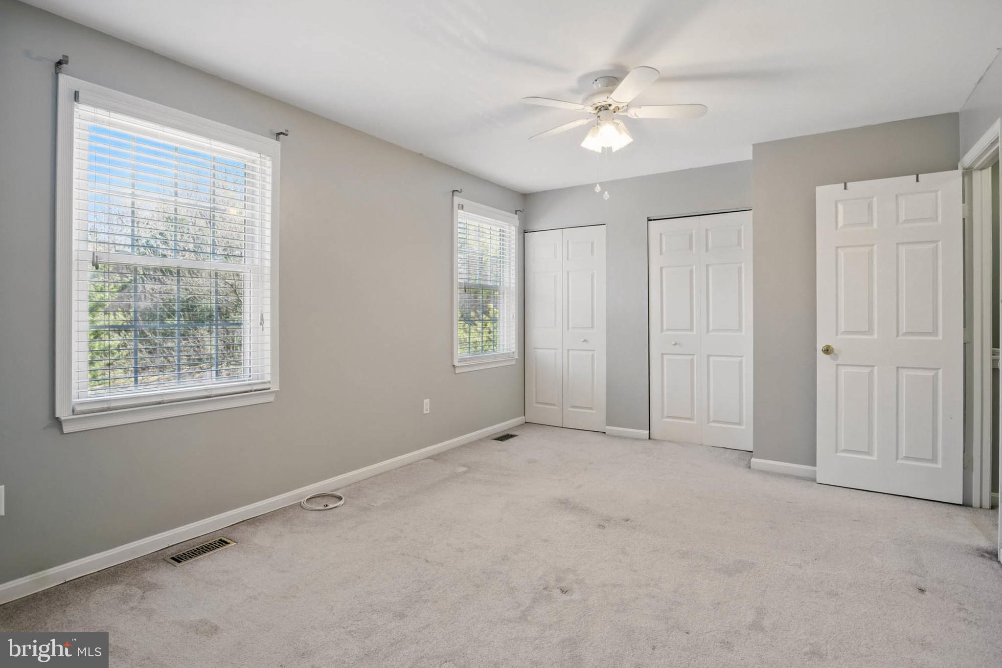 7812 Solari Court Pasadena, MD 21122 - Photo 12 of 30 an empty room with windows and fan