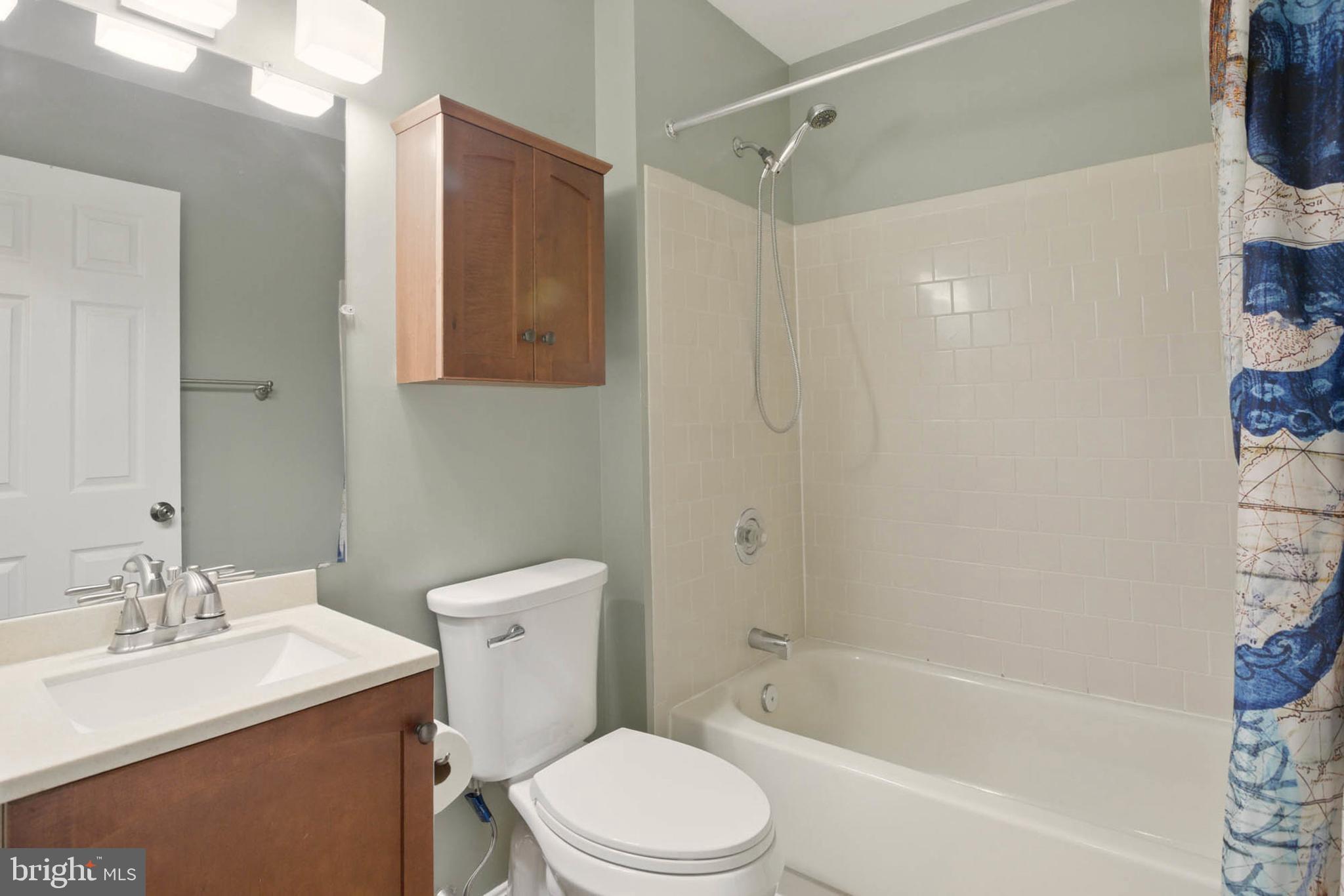 7812 Solari Court Pasadena, MD 21122 - Photo 26 of 30 a bathroom with a sink a toilet and shower
