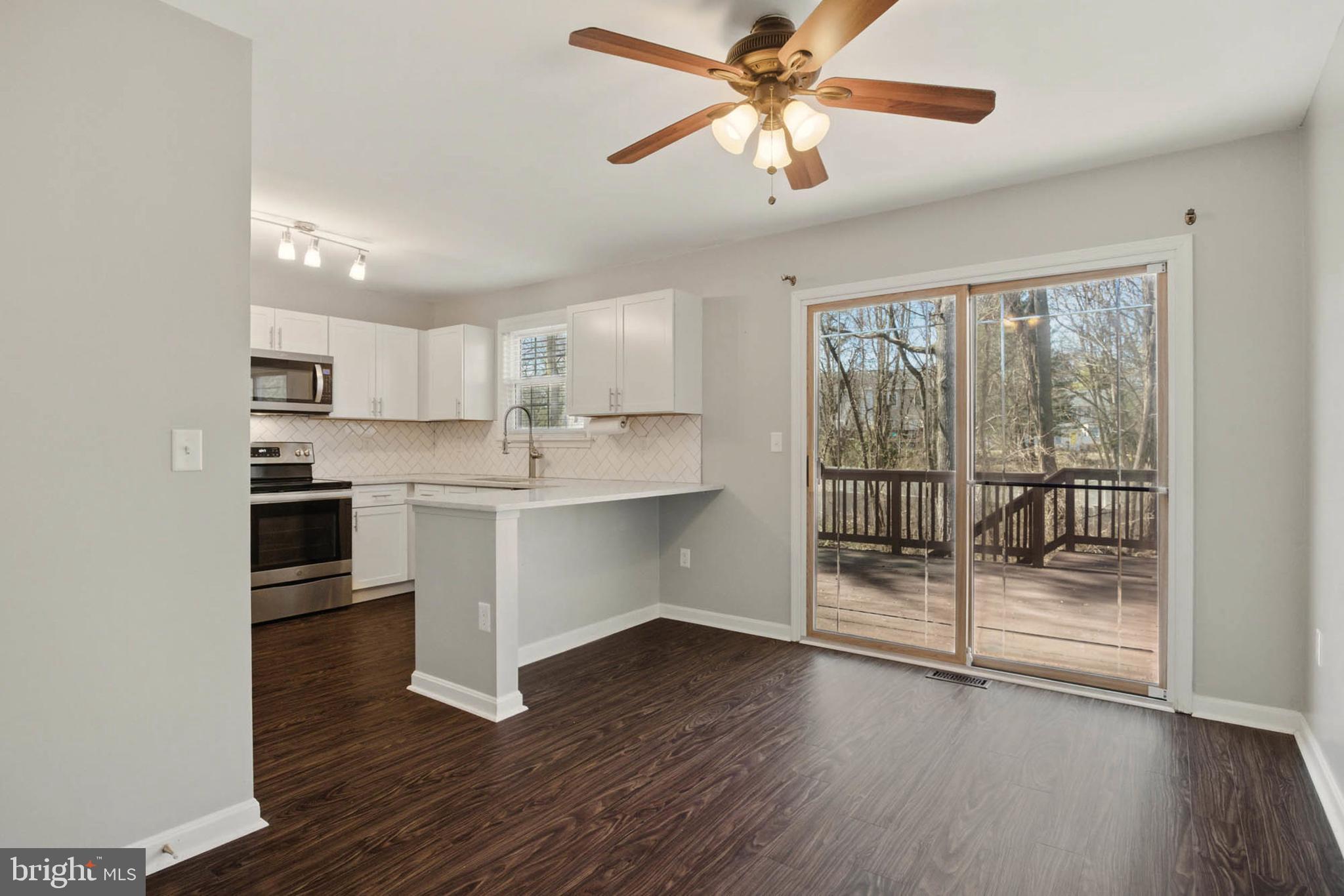 7812 Solari Court Pasadena, MD 21122 - Photo 6 of 30 a kitchen with wooden floors and appliances