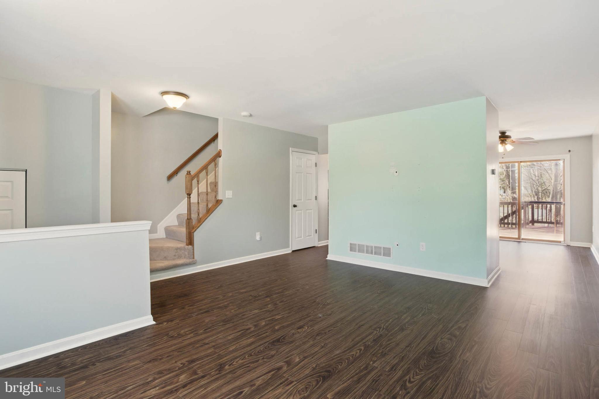 7812 Solari Court Pasadena, MD 21122 - Photo 9 of 30 a view of an empty room with wooden floor and a window