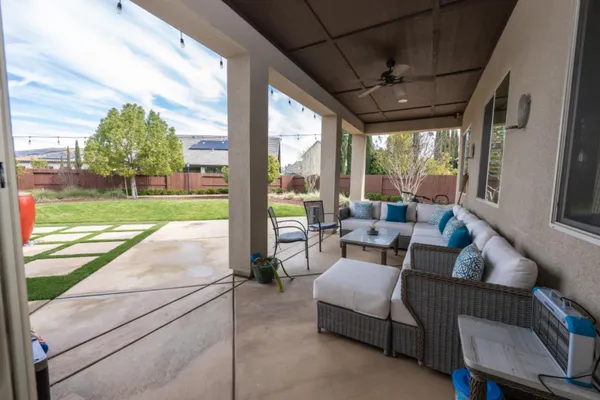 a white house that has tree in front of it