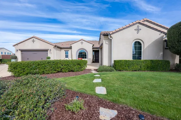 a front view of a house with a yard