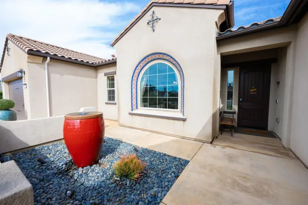 a kitchen with stainless steel appliances kitchen island granite countertop a sink counter space and a refrigerator