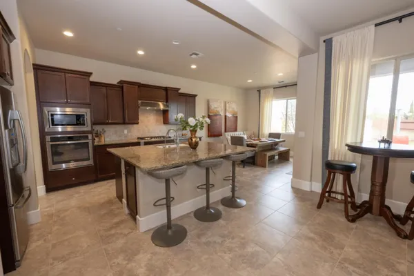 a dining room with furniture and flowers