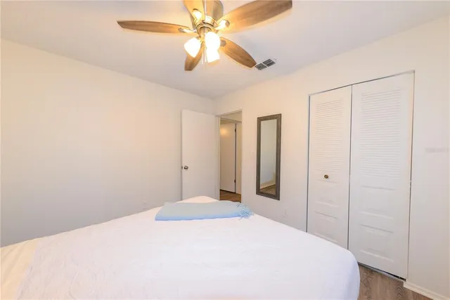 a bedroom with a large bed and a chandelier