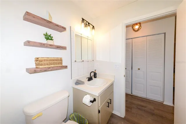 a bathroom with a sink a mirror and a toilet