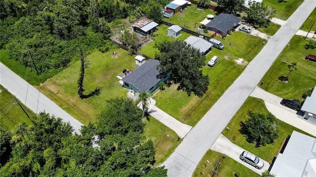 an aerial view of a residential houses with outdoor space