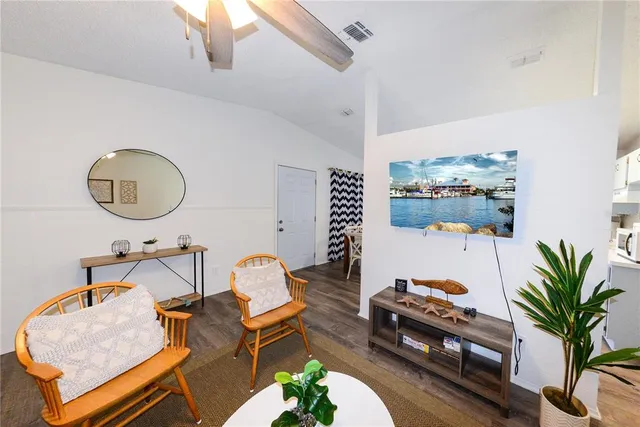a living room with furniture flowerpot and a potted plant
