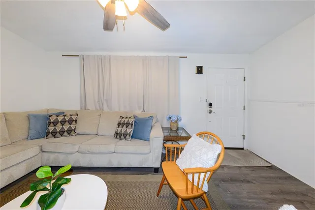 a living room with furniture a rug and a window