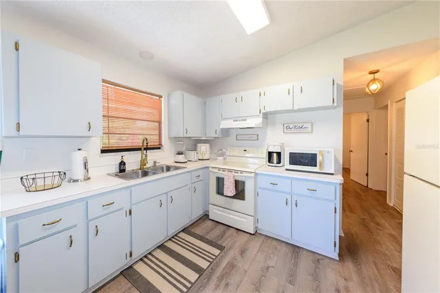 a kitchen with sink cabinets and window