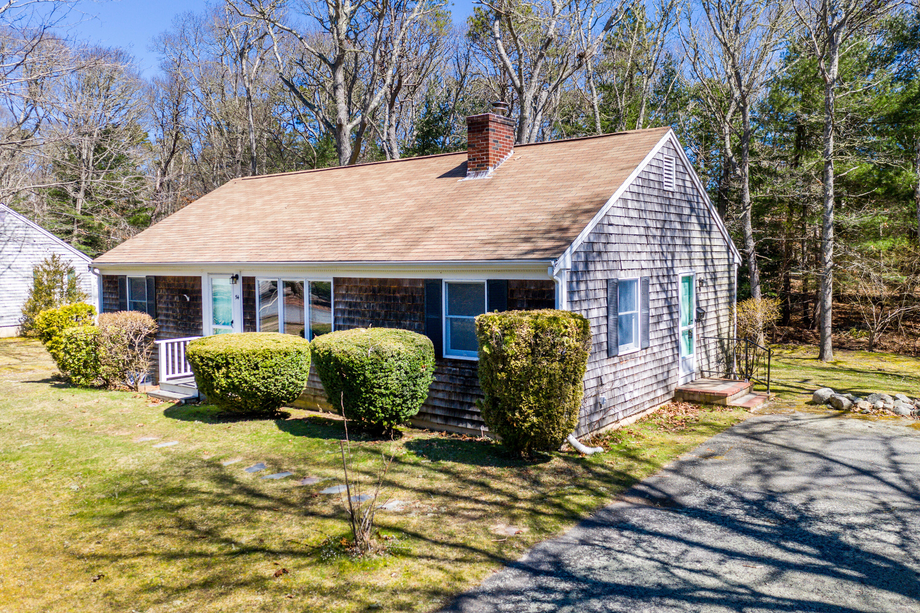 54 Hinckley Circle Osterville, MA 02655 - Photo 1 of 30 a backyard of a house with yard and outdoor seating