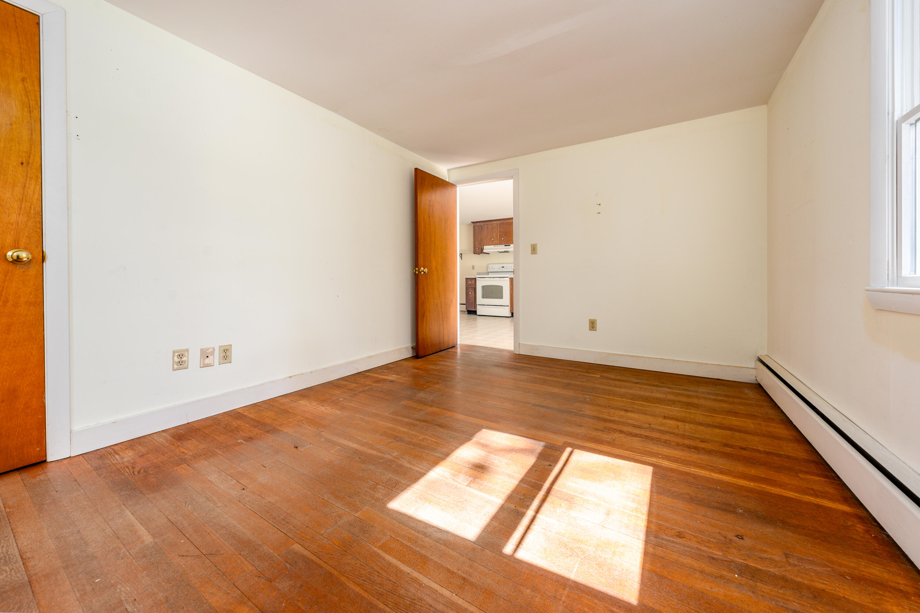 54 Hinckley Circle Osterville, MA 02655 - Photo 11 of 30 an empty room with wooden floor and windows