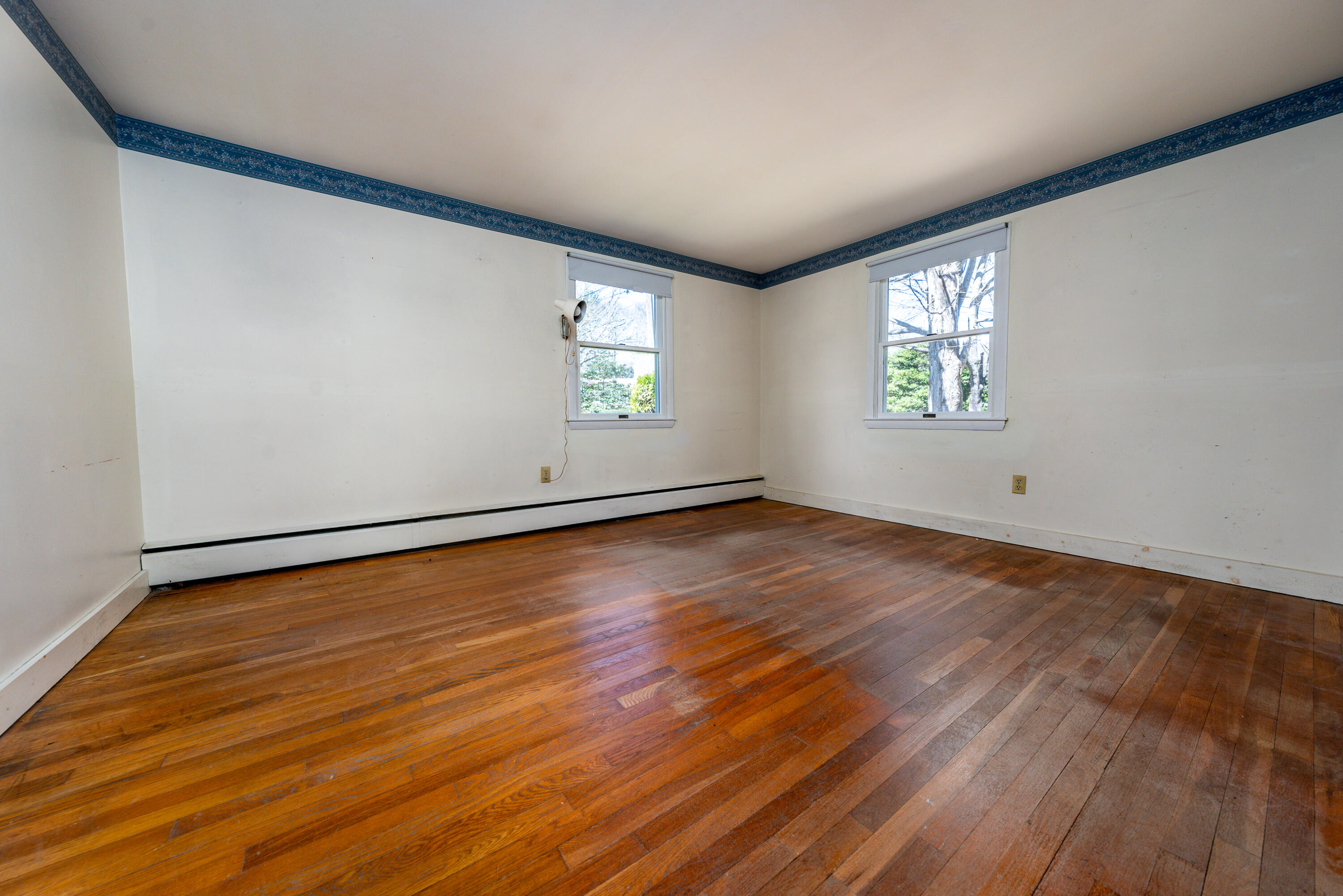 54 Hinckley Circle Osterville, MA 02655 - Photo 13 of 30 an empty room with wooden floor and windows