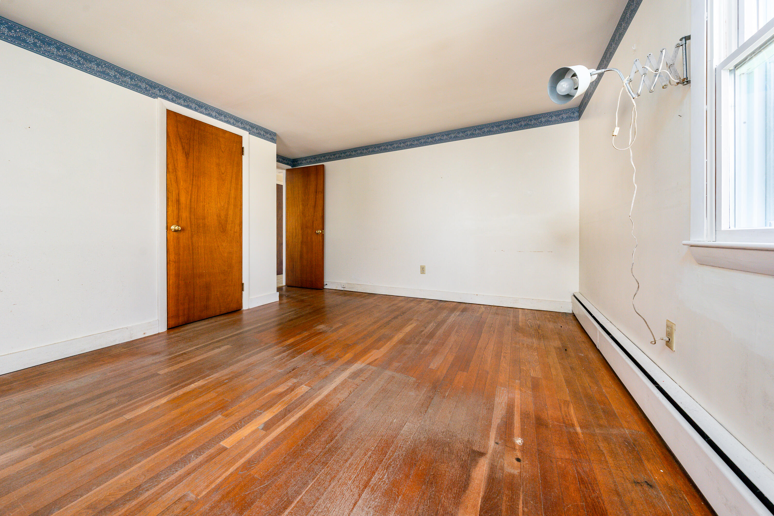 54 Hinckley Circle Osterville, MA 02655 - Photo 14 of 30 a view of an empty room with wooden floor and a window