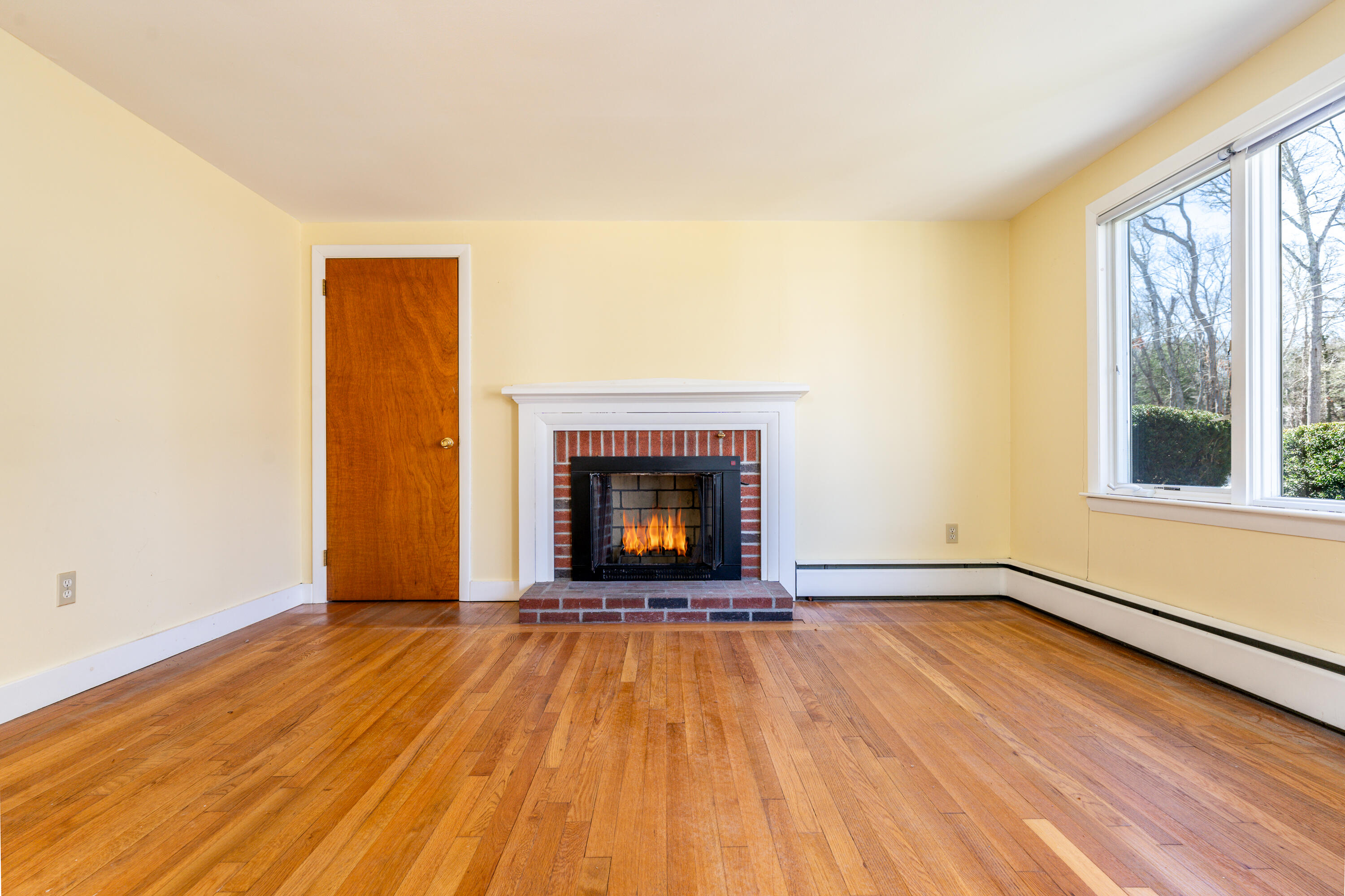54 Hinckley Circle Osterville, MA 02655 - Photo 4 of 30 a view of an empty room with a window and wooden floor