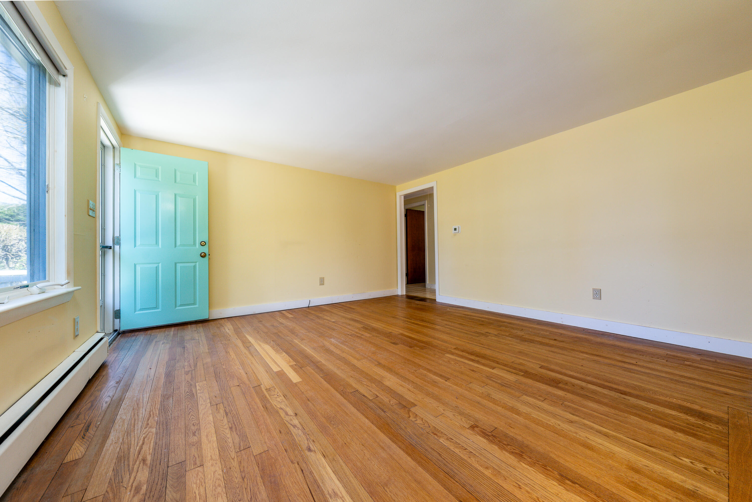 54 Hinckley Circle Osterville, MA 02655 - Photo 5 of 30 a view of an empty room with wooden floor and a window