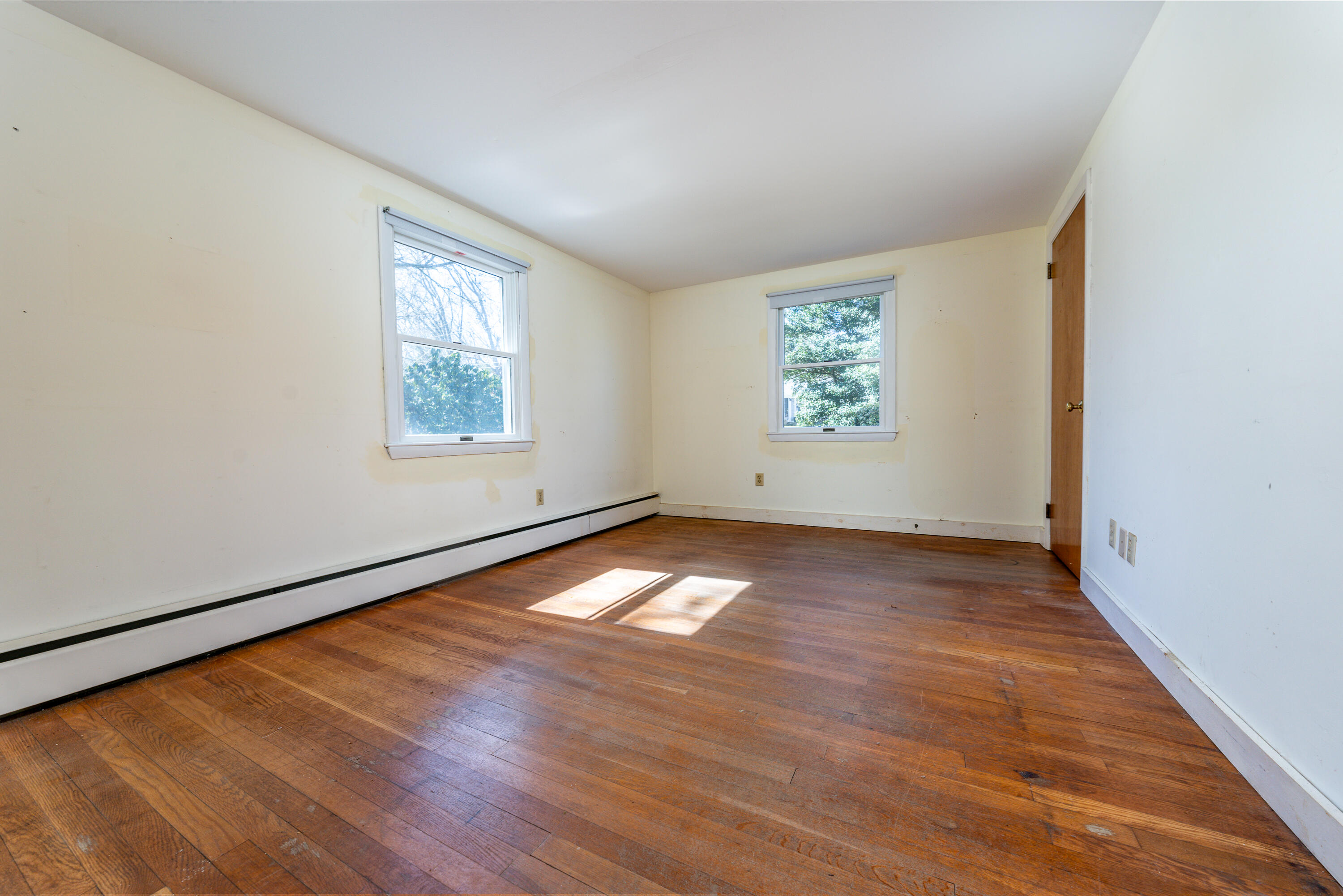 54 Hinckley Circle Osterville, MA 02655 - Photo 10 of 30 an empty room with wooden floor and windows