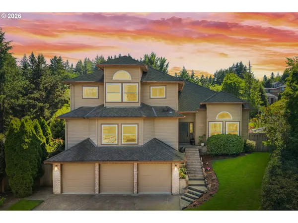 a front view of a house with a yard and garage