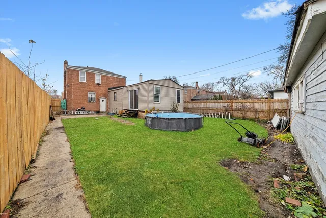 a view of a house with a yard and sitting area