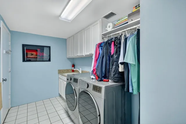 a bathroom with a double vanity sink and mirror