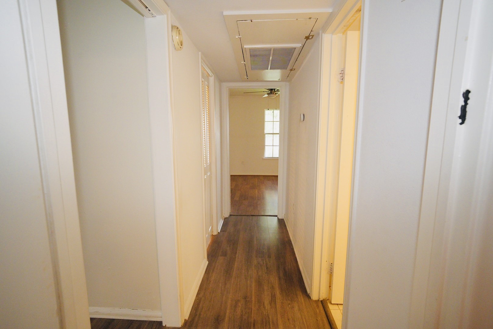 7600 Burgoyne Road, Unit 250 Houston, TX 77063 - Photo 11 of 14 This inviting hallway features sleek hardwood floors and ample natural light, creating a warm and welcoming path to your home's private spaces.