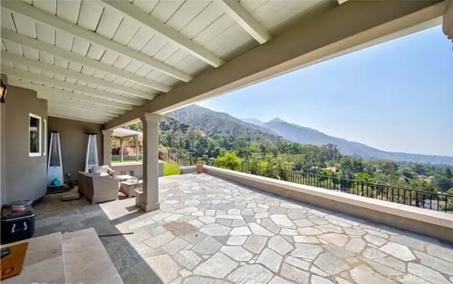 a view of a porch with furniture and a backyard