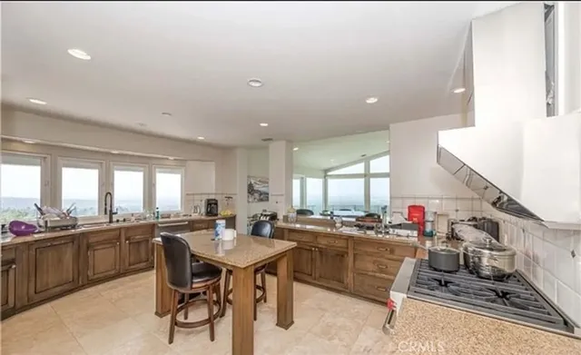 a kitchen with lots of counter top space and dining table
