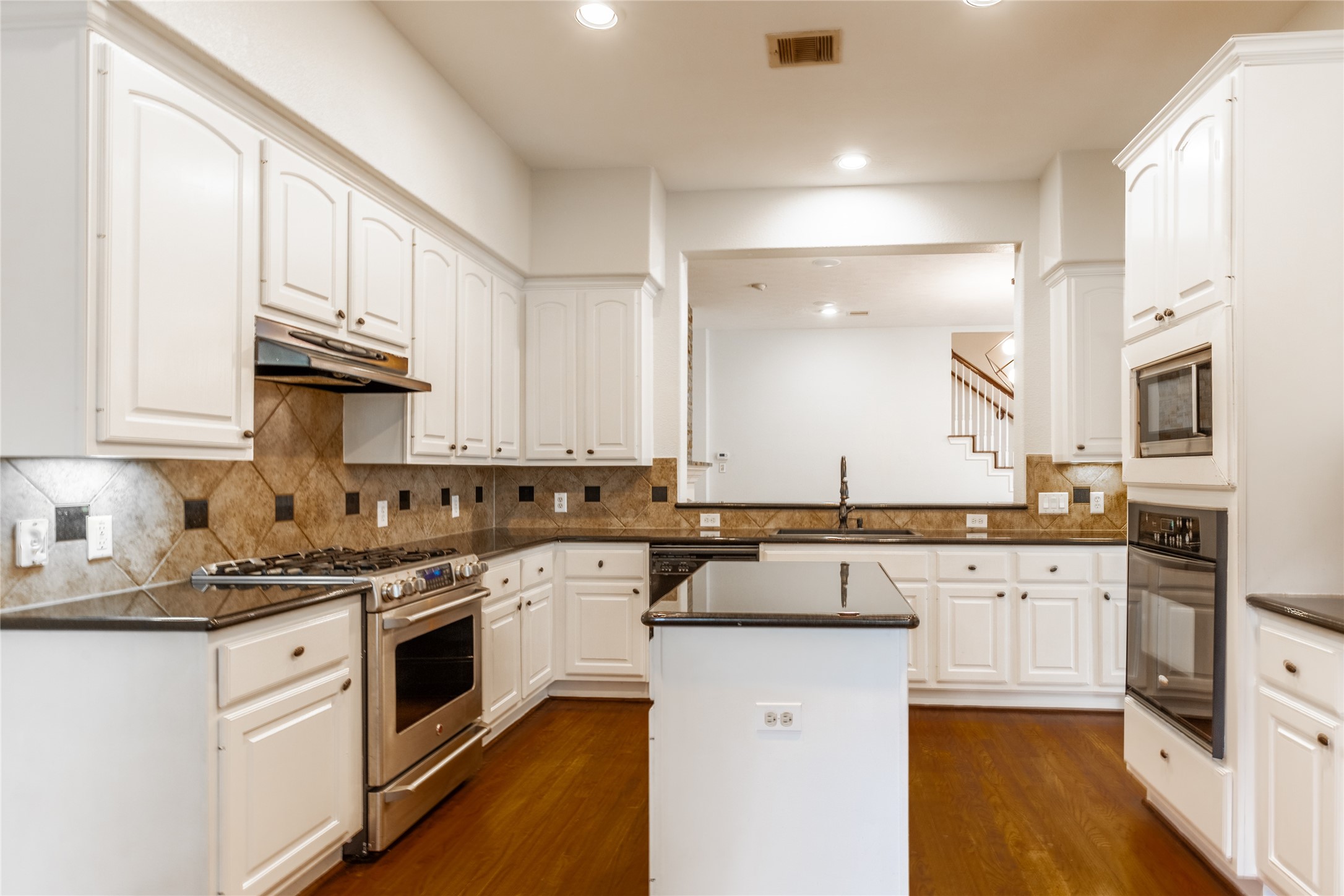 2923 Royal Oaks Crest Houston, TX 77082 - Photo 11 of 31 a kitchen with stainless steel appliances granite countertop a stove sink microwave and cabinets