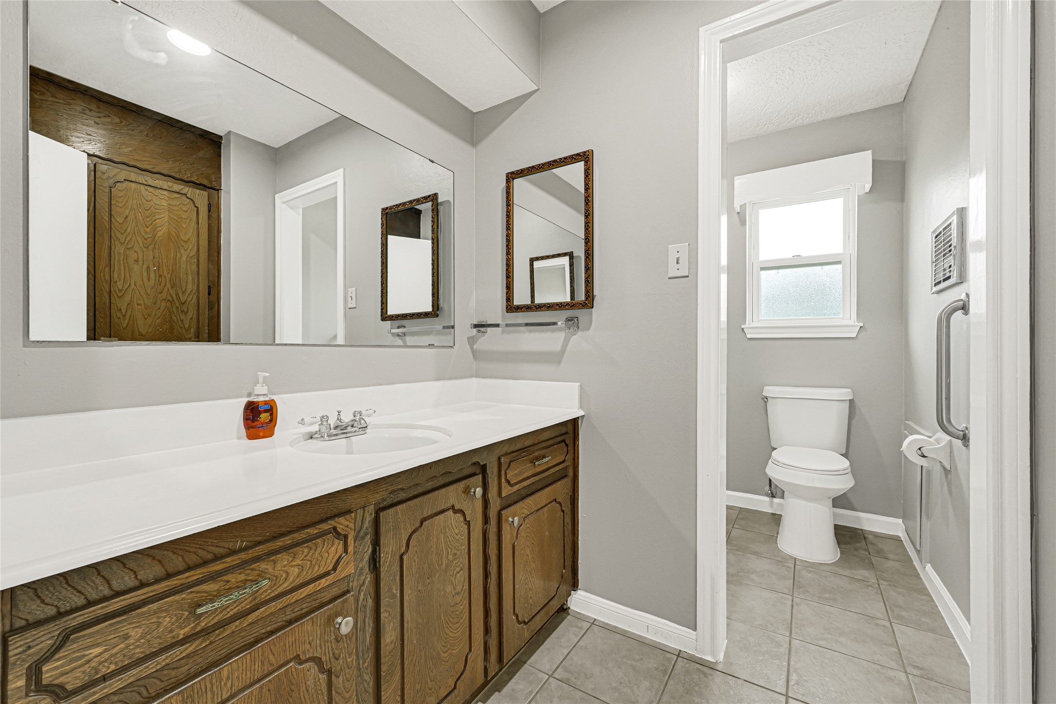20135 Timber Line Lane New Caney, TX 77357 - Photo 18 of 30 a bathroom with a sink a toilet and a mirror