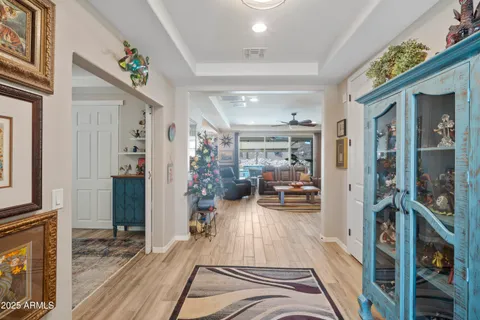 a living room with furniture a fireplace and a chandelier