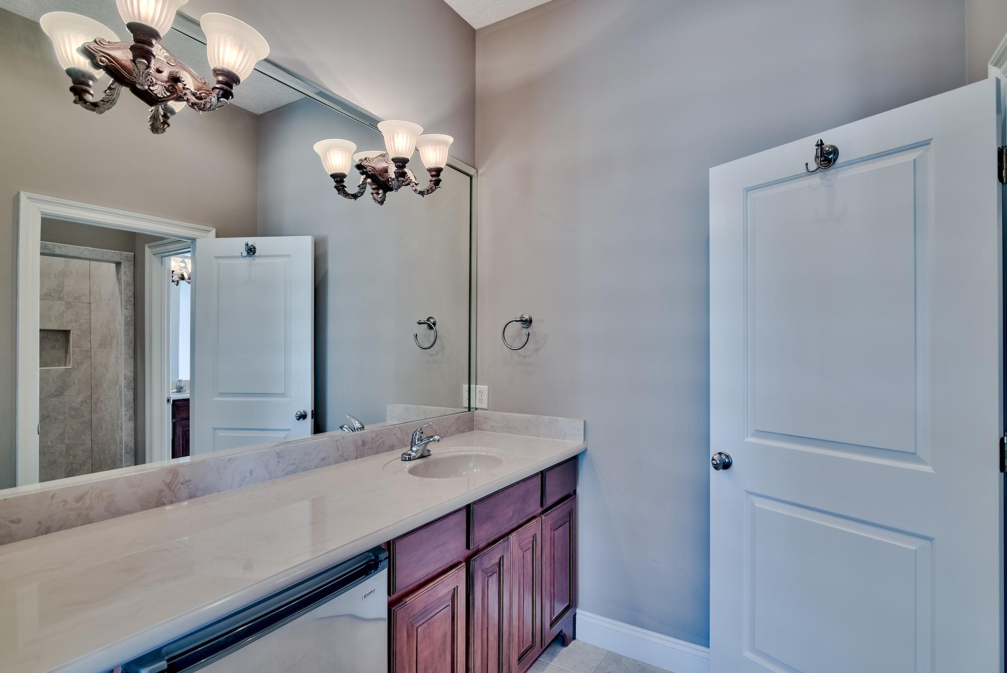 103 Pelican Glide Lane Inlet Beach, FL 32461 - Photo 29 of 47 a bathroom with a double vanity sink and mirror