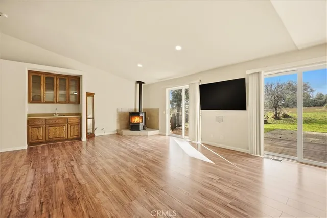 a view of a livingroom with wooden floor and flat screen tv