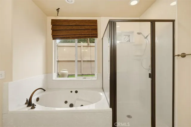 a bathroom with a bathtub and a window