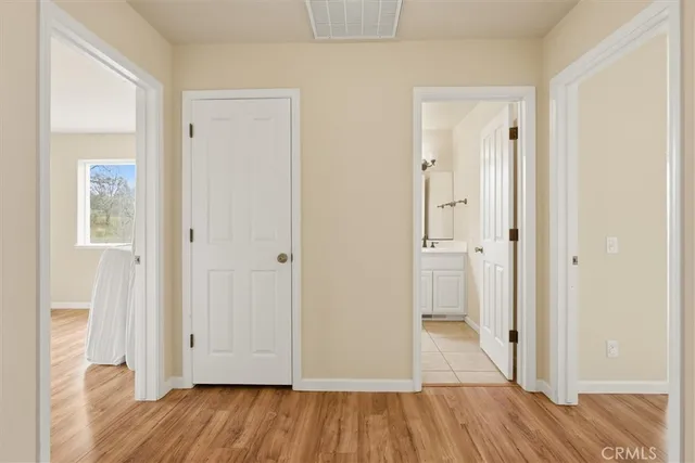a view of a hallway with wooden floor