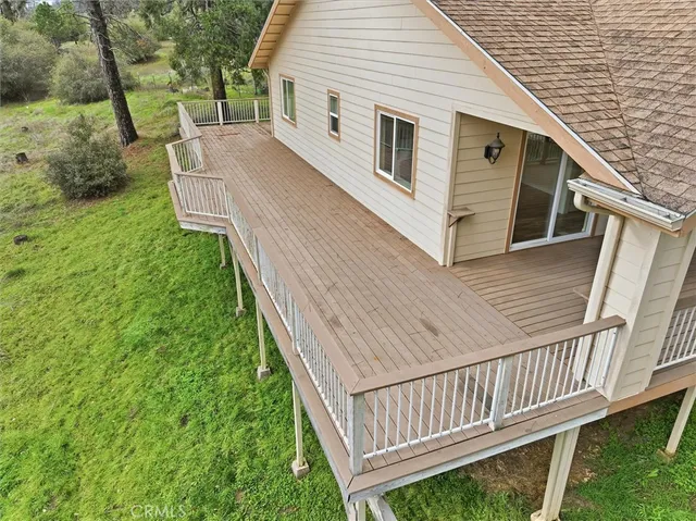 a white house that has tree in front of it