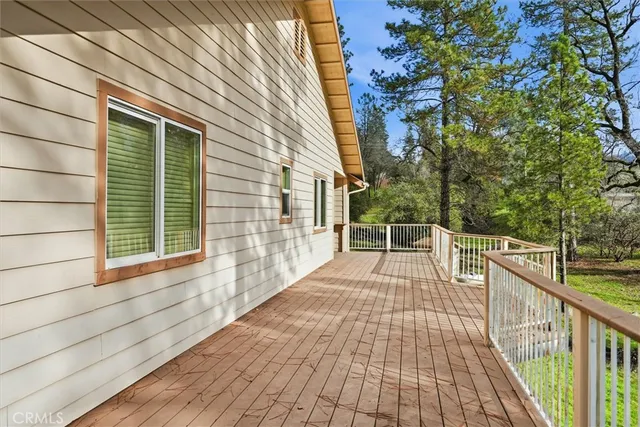 a view of a balcony with wooden floor and fence